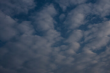 Beautiful clouds roaming in the red and bluish sky during sunset in the afternoon. Indian landscape and sky.