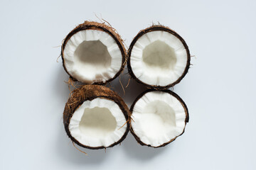 Fototapeta na wymiar top view of fresh tasty coconut halves on white background