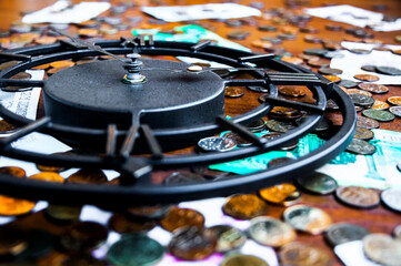 Time is money concept with iron wall clock, coins and banknotes	