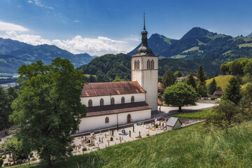 Fototapeta premium The Eglise Saint Theodule and Saane valley - Gruyeres, Switzerland