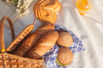 Lunch in the park on the green grass. Summer sunny day and picnic basket