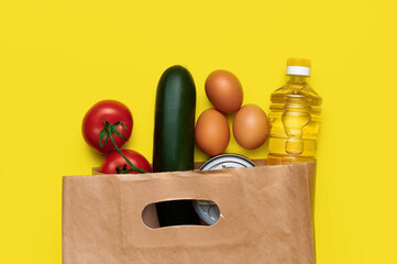 Red tomatoes, zucchini, chicken eggs, canned food, sunflower oil in paper bag. Fresh vegetables in...