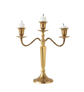 Gold classic candlestick with three candles on a white background