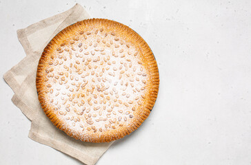 Italian Grandma's cake - Torta della nonna.  Pine nut custard tart from Tuscany, Italy. Flat lay.