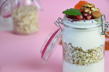 Healthy breakfast overnight oats with fresh berries in a glass jar with dried fruits, apple and nuts, walnuts, almonds. with yogurt, cottage cheese, pudding. diet, keto diet