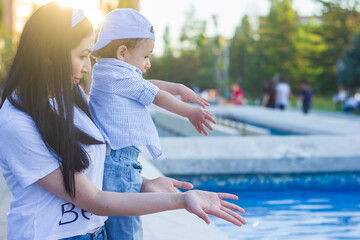 mother and little boy standing near the pool