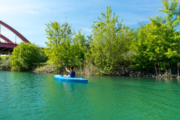 Woman kayaking on the Störmthaler Lake near Leipzig on a sunny day