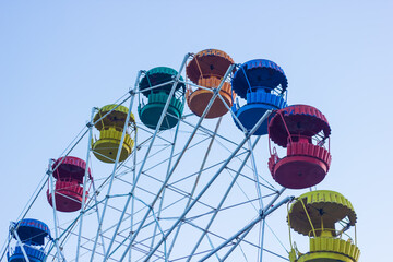 ferris wheel on a blue sky, colored ferris wheel in the park