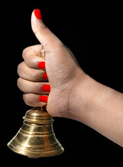 Hand held puja bell With Black Background for Indian bengali rituals for Ganesh Puja, durga puja, kali puja, lakshmi, saraswati. © 7G Studio