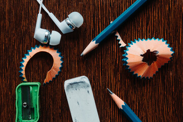Flat lay shot of pencil and other stationary items on the table 