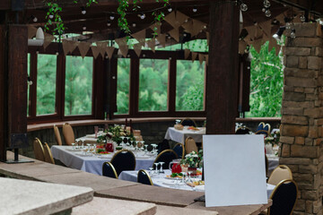 White placard for Seating guests at the wedding .