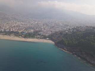 Aerial view of the coast of the sea in Alanya, view of the coast of the mediterranean sea, view of the beach, waves on the beach, turkey, alanya, kemer, travel around turkey, mountains