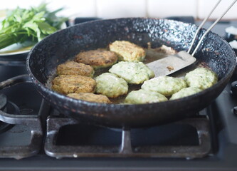 Healthy vegetarian and dietary food. Vegetable and fish cutlets with greens on a wooden background.