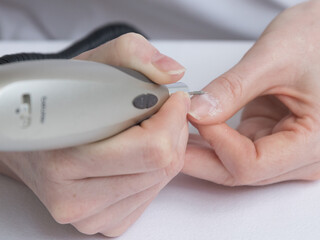 Home manicure. The care and treatment of the nails using a special apparatus. Self-care for nails,...