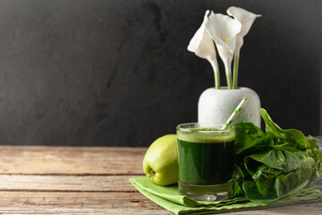 Healthy green smoothie on vintage wooden table. Fresh detox nutrient.