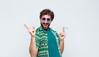 young hippie man smoking a joint against white wall