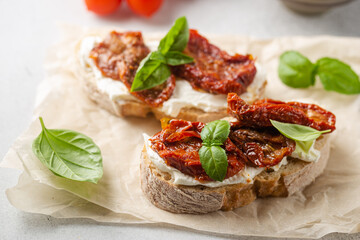 Bruschetta with sundried tomatoes, cottage cheese and fresh basil. Tasty savory Italian appetizers