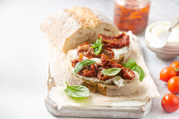 Bruschetta with sundried tomatoes, cottage cheese and fresh basil. Tasty savory Italian appetizers