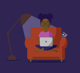 Young woman sitting on a sofa with a laptop in the middle of the night.