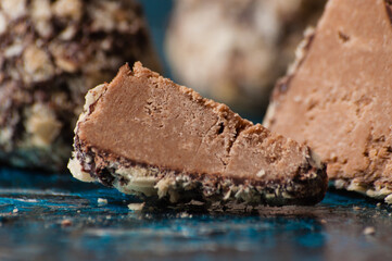 Delicious chocolates in waffle crumbs cut into slices, in half, close-up macro, side view and top view