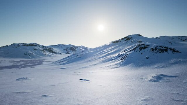 Aerial Landscape of snowy mountains and icy shores in Antarctica