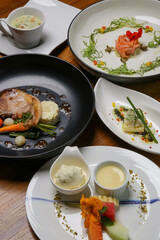 A full-course dinner on the restaurant table. Various meals and desserts served at the restaurant table.