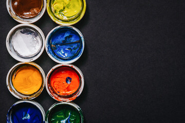 lids from jars of paint with remnants of paint on the back, background for the artist