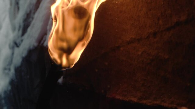 burning torch illuminating the wall of snow cave