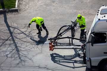 Road surface restoration work. The worker performs on road patcher work on the repair of cracks by...