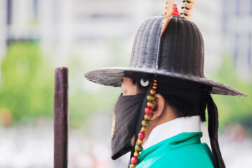Covid 19/ Corona Serie 
Korean tourism, Gyeongbokgung Palace, Seoul 
Guard in mask