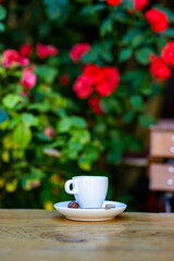 cup with coffee stands on a table on the background of a city cafe