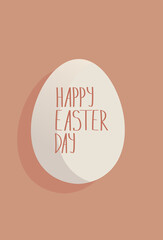 White egg with an Easter inscription on it. Coral background