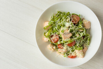 Spinach Tagliatelle with salmon in a cream sauce and parmesan on white dish, top view. Mediterranean cuisine.