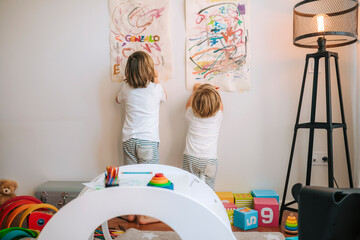 Little blond children plays painting at home. entertainment during quarantine. family at home