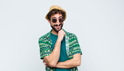 young tourist man smiling, enjoying life, feeling happy, friendly, satisfied and carefree with hand...