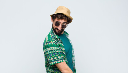 young tourist man looking proud, confident, cool, cheeky and arrogant, smiling, feeling successful...