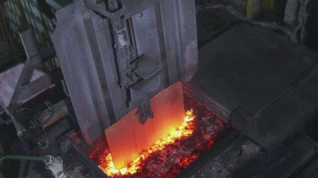 Automated copper feed line to the furnace. The melting of copper in the furnace, the process of melting copper in the furnace.