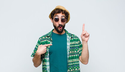 young tourist man feeling proud and surprised, pointing to self confidently, feeling like...