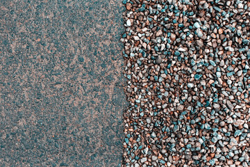 Abstract background of wet asphalt and small pebbles.