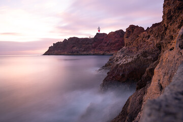 Lighthouse views with mountains and sea, Long exposure