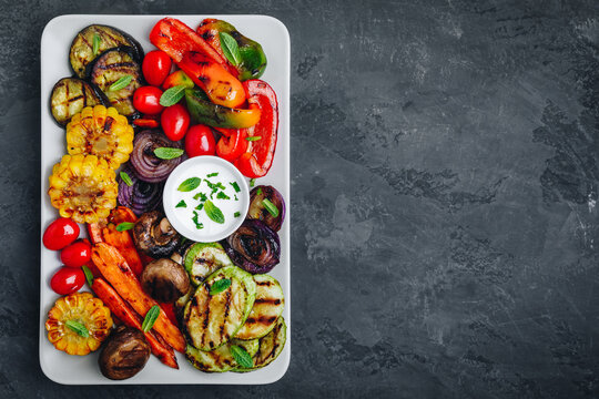 Grilled Vegetable Platter With Zucchini, Mushrooms, Eggplant, Carrots, Pepper Bell, Tomato, Onions, Corn, And Yogurt Mint Sauce