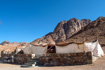 A shabby berber or bedouin tent in the desert surrounded by mountains in Sinai, Egypt