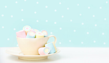 Marshmallows in a mug on a white table