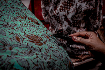 Surakarta Indonesia, June 02 2020 : Closeup Canting and batik painting on the fabric Indonesia