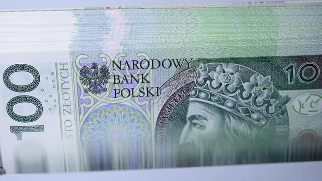 Close Up Of Stack Of One Hundred Zloty Of Foreign Currency Being Counted. 