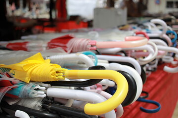Fototapeta premium Yellow umbrella among many umbrellas at flea market