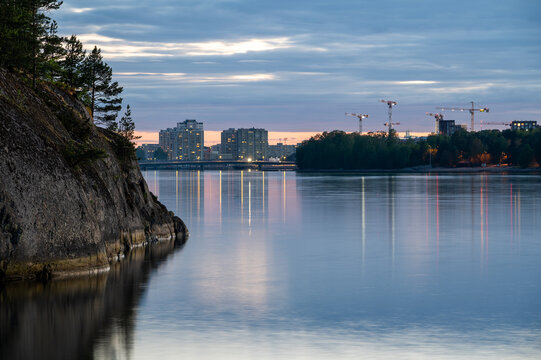 Helsinki city skyline between two islands on a calm summer night.