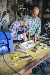Senior couple working in a carpentry workshop