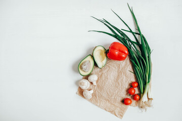Set of different fresh vegetables on a white wooden table background. Top view. Copy, empty space for text