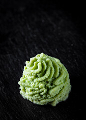 Wasabi sauce on black stone background